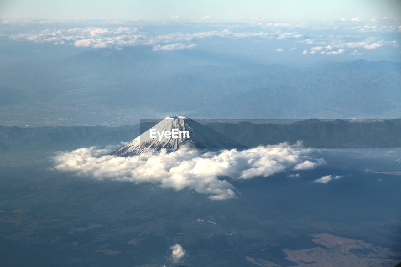 High angle view of snowed mountain amid clouds