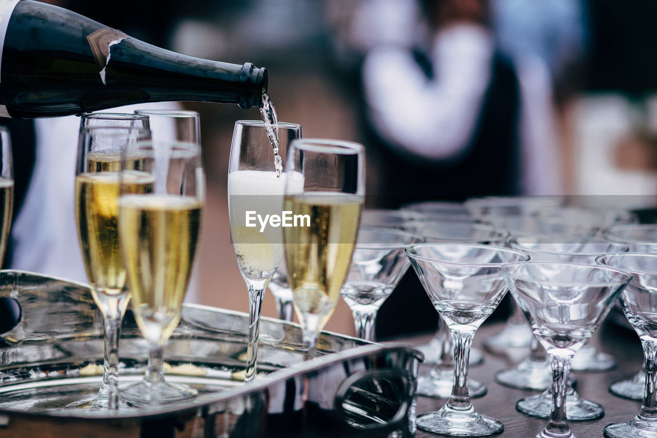 Wine pouring in glasses on table in restaurant