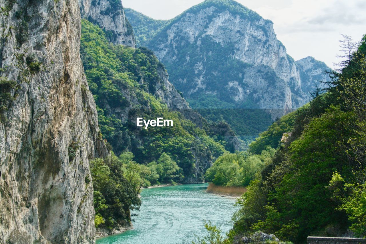 Scenic view of river amidst mountains