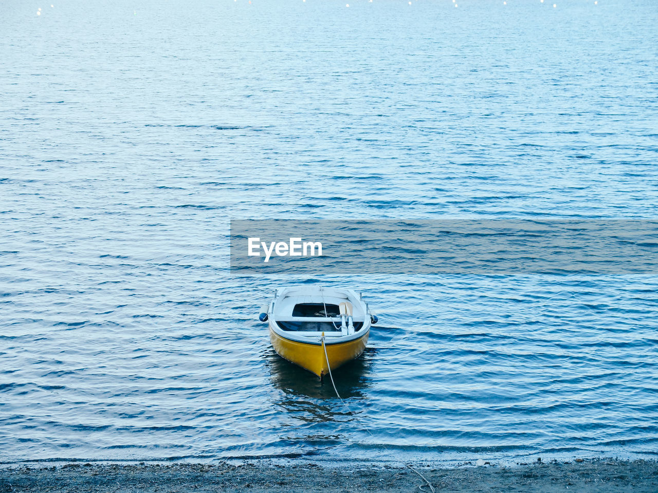 Yellow boat at shore