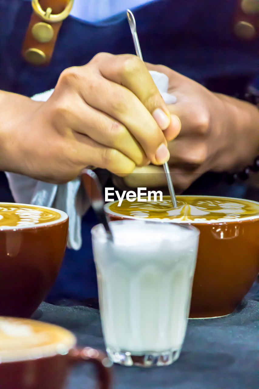 CLOSE-UP OF PEOPLE HOLDING DRINK