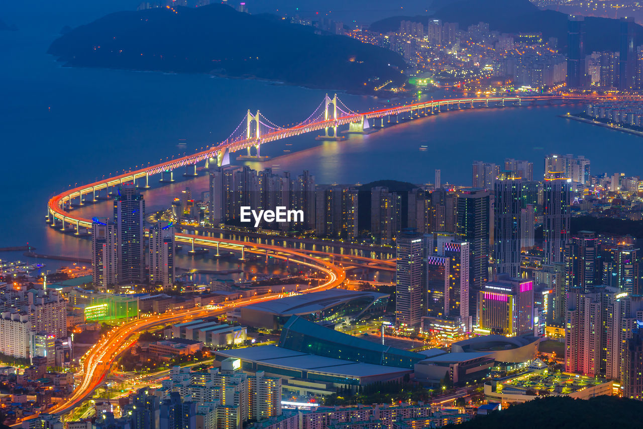 High angle view of illuminated city buildings at night