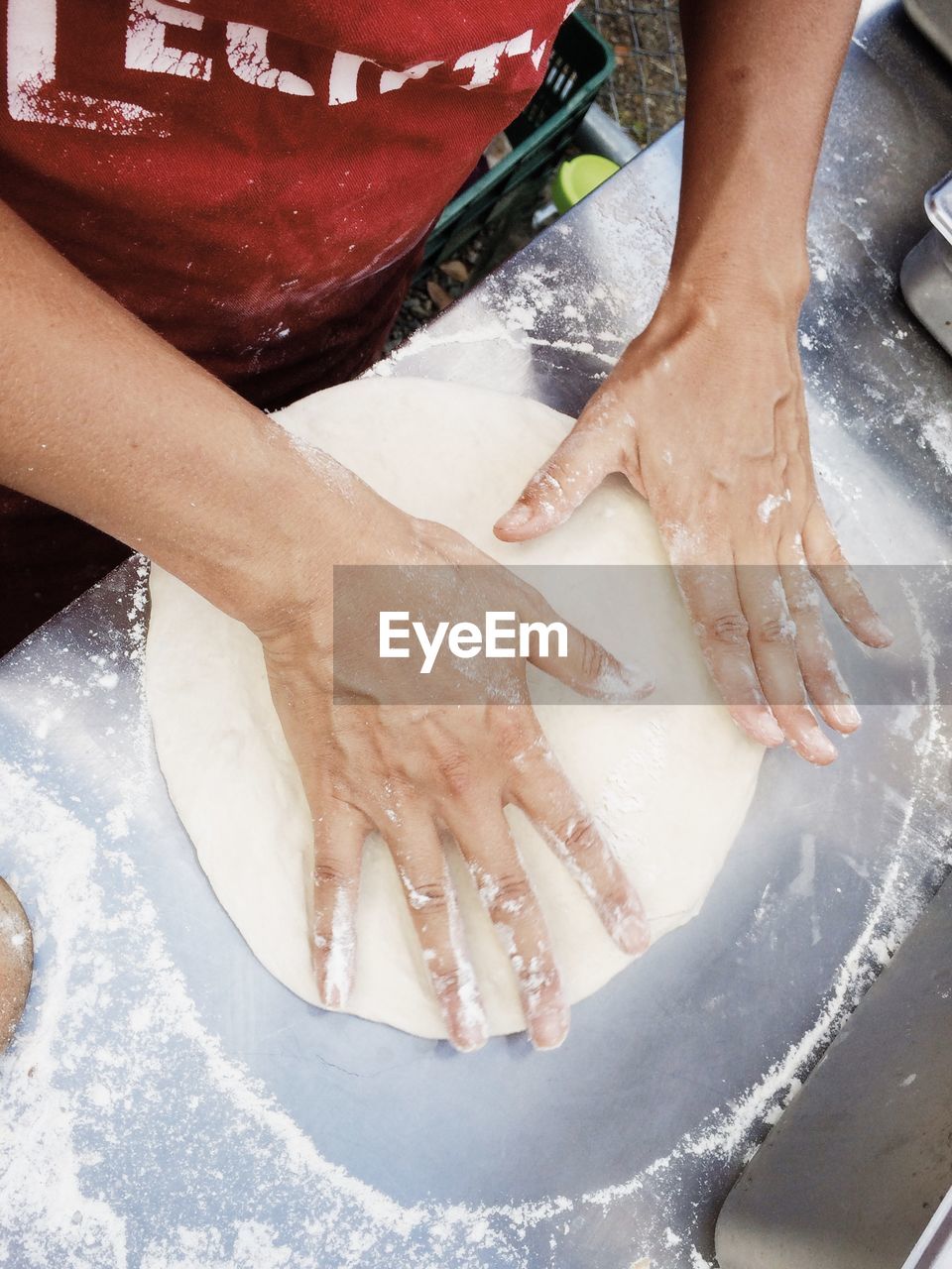 High angle view of person making dough on table