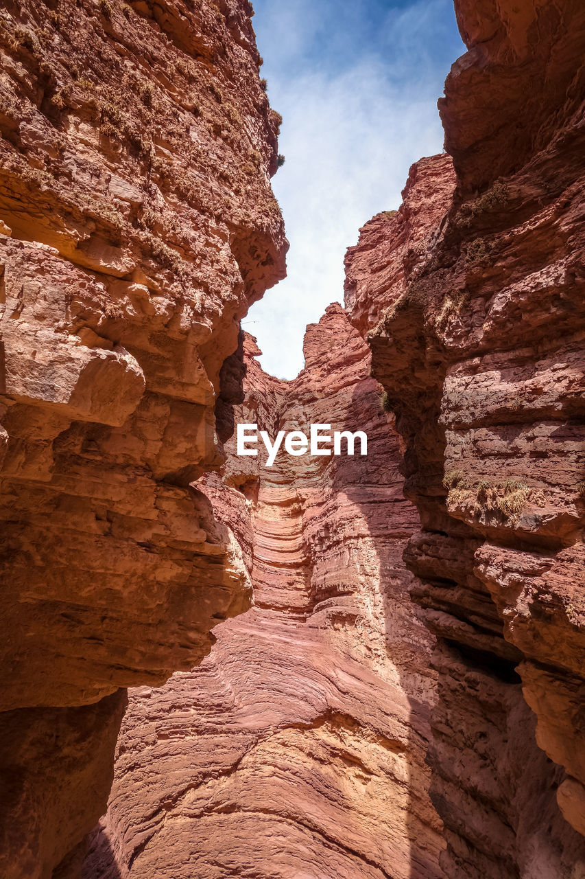 LOW ANGLE VIEW OF ROCK FORMATION IN MOUNTAIN