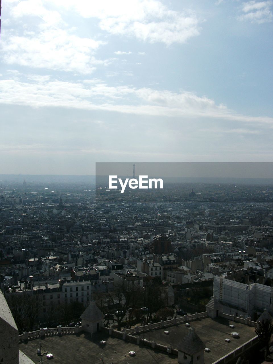 Aerial view of city against cloudy sky