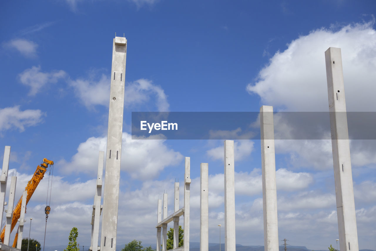 LOW ANGLE VIEW OF SMOKE STACK AGAINST SKY IN BUILDING