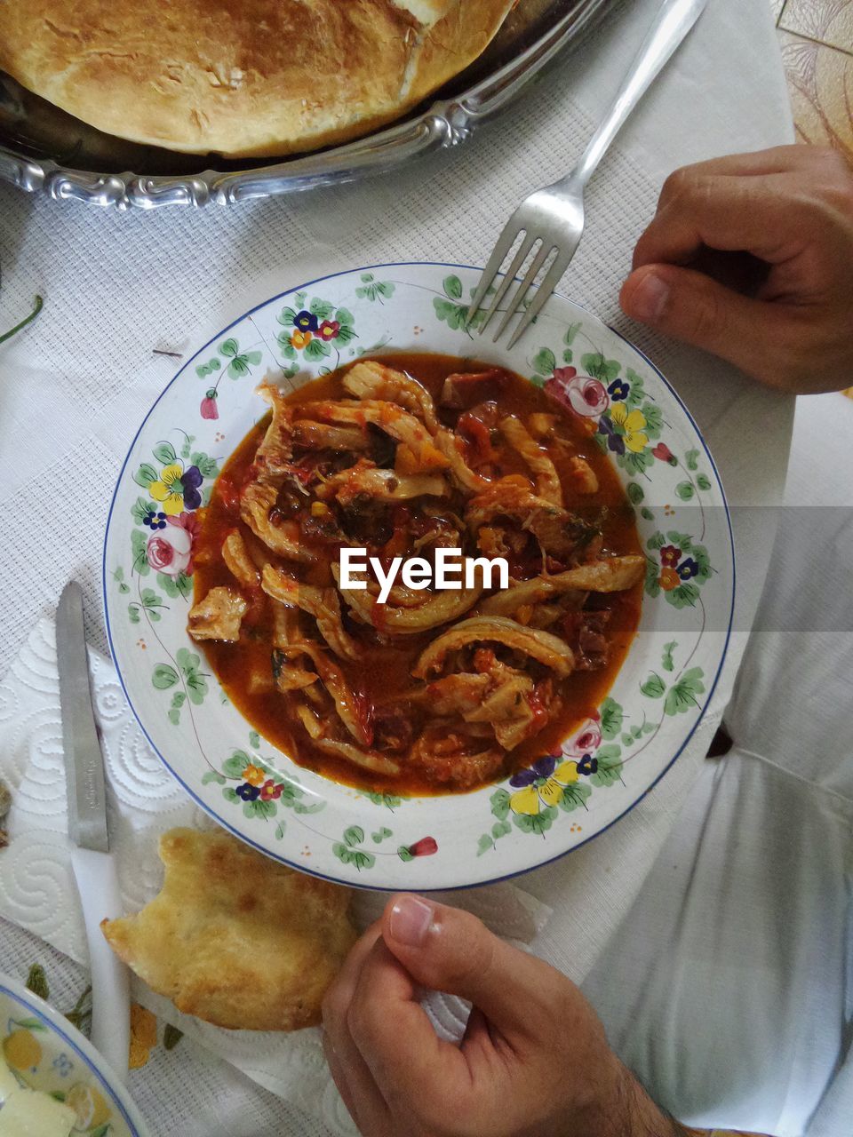 High angle view of person eating tripe penne in plate