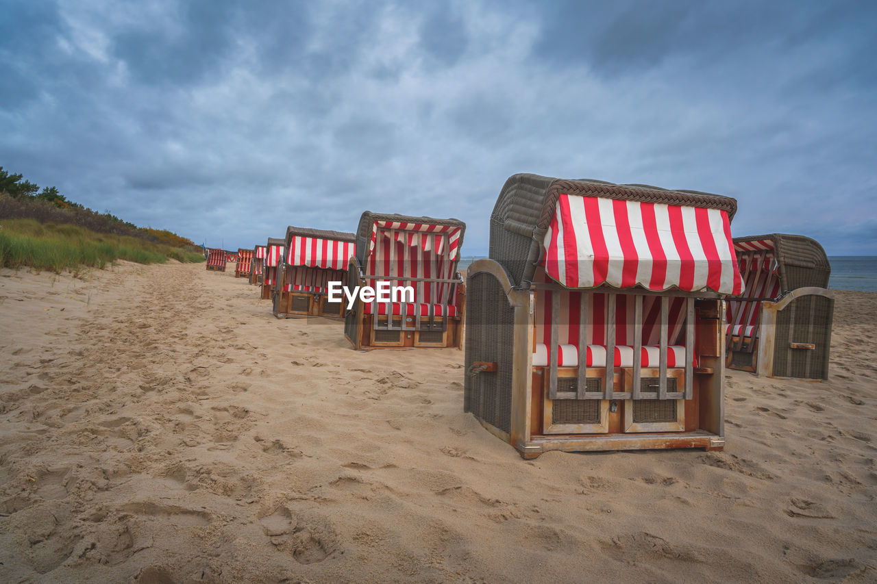 EMPTY CHAIRS ON BEACH