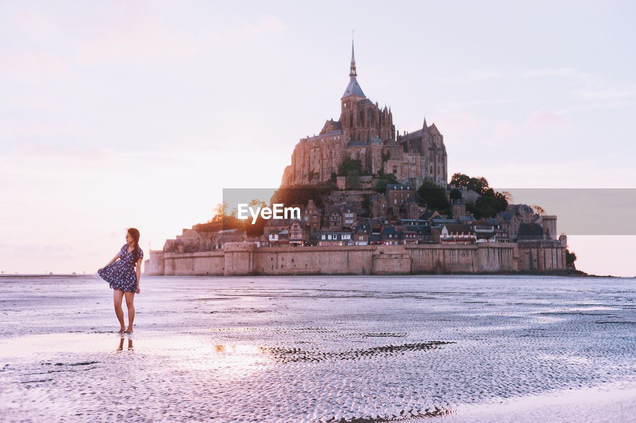 Woman standing in front mont saint michel island