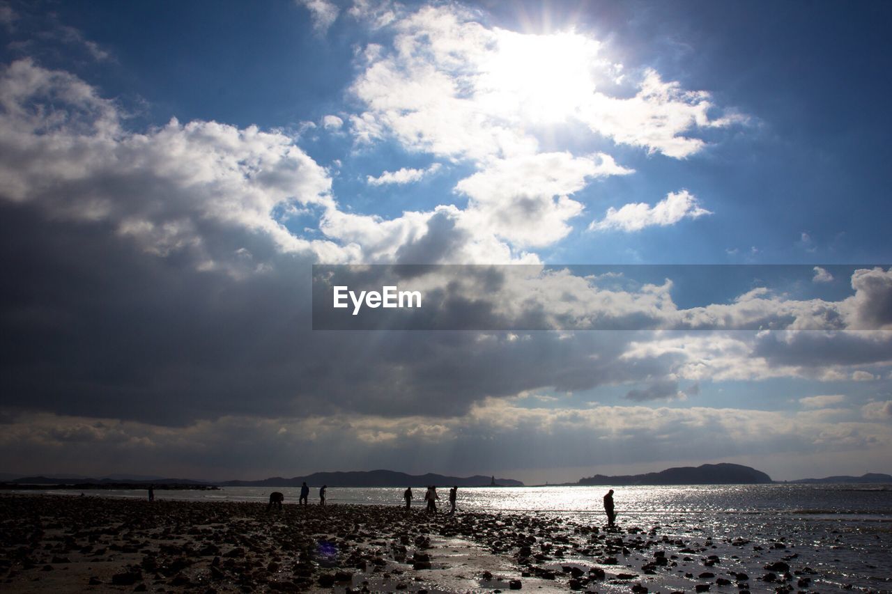 VIEW OF CALM BEACH AGAINST CLOUDS