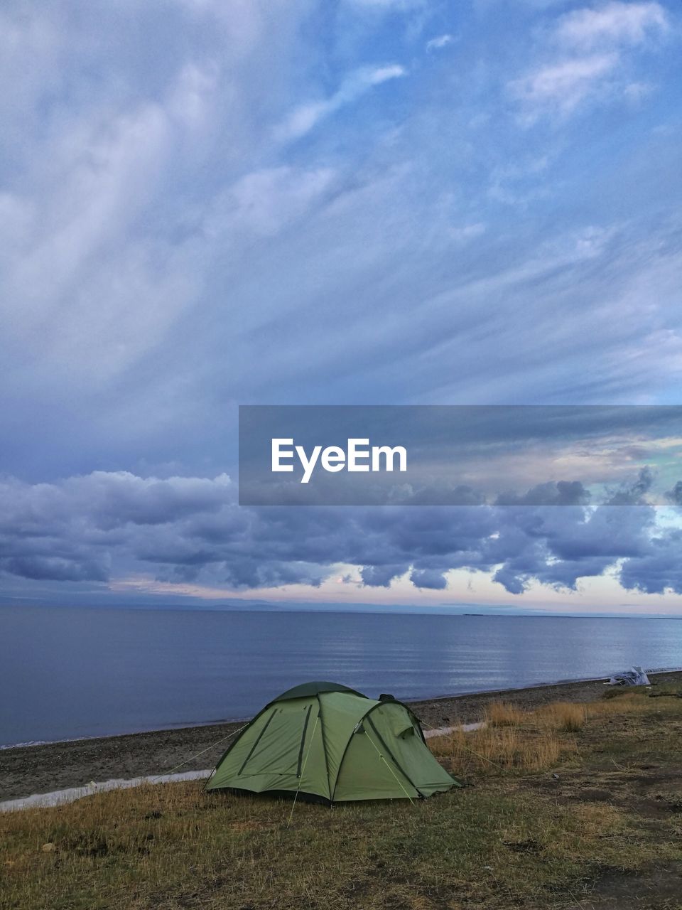 TENT ON BEACH AGAINST SKY