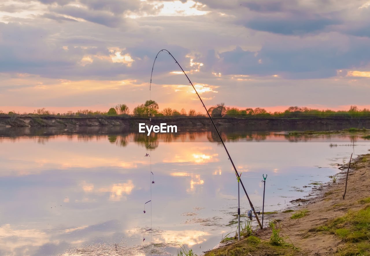 SCENIC VIEW OF LAKE AGAINST ORANGE SKY