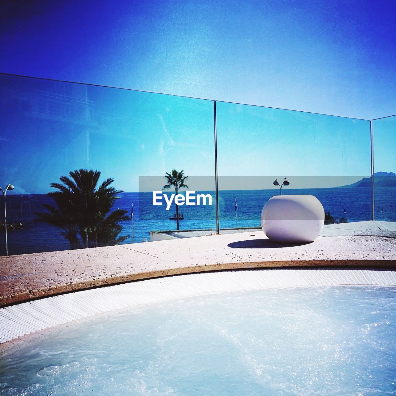 SWIMMING POOL BY SEA AGAINST BLUE SKY