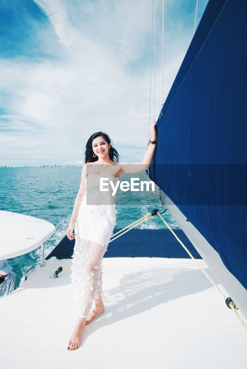 Full length portrait of woman standing in nautical vessel