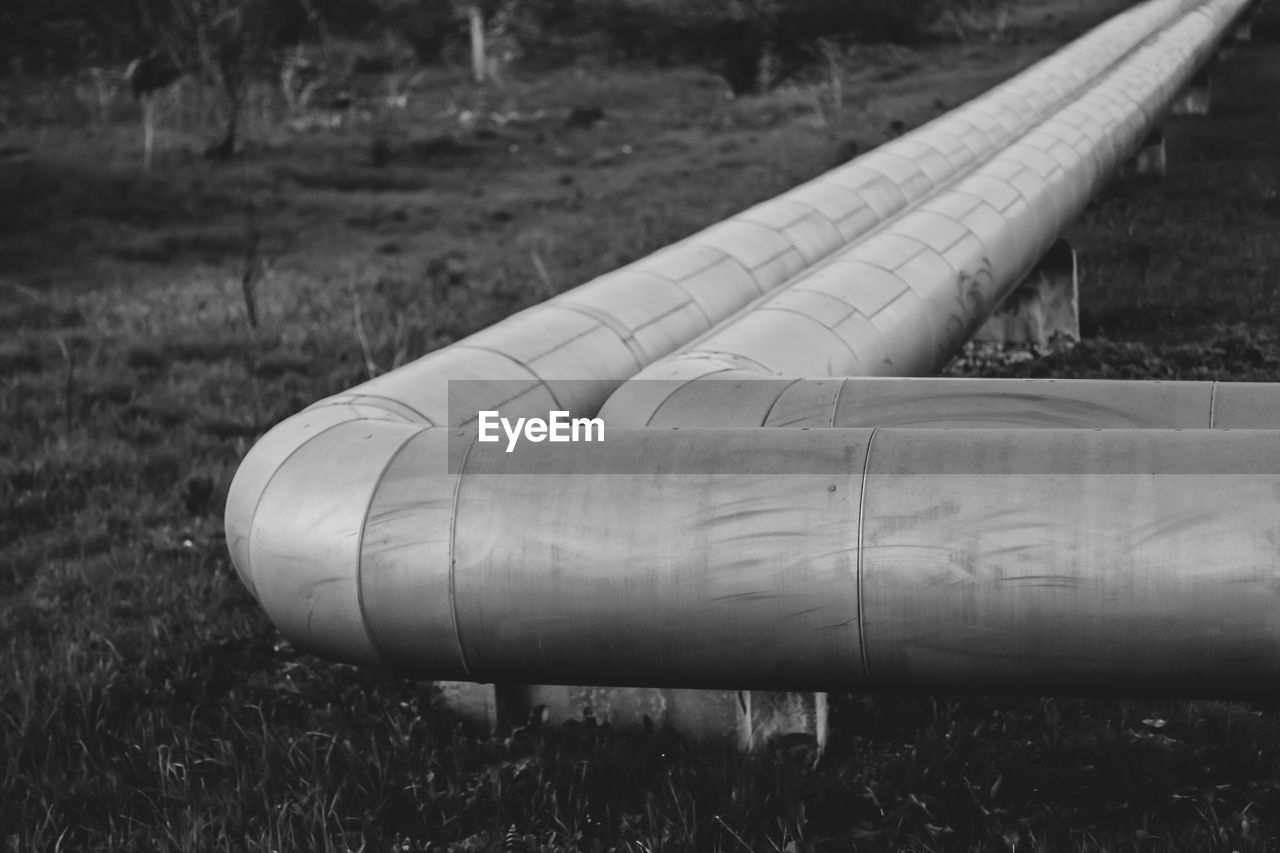 CLOSE-UP OF PIPE ON LAND