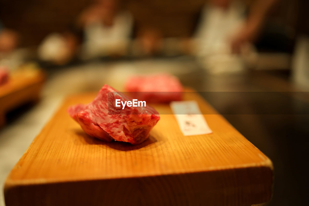 food and drink, food, meat, freshness, kobe beef, focus on foreground, indoors, red meat, table, beef, raw food, close-up, cutting board, meal, cuisine, business, wood, cooking, selective focus, restaurant