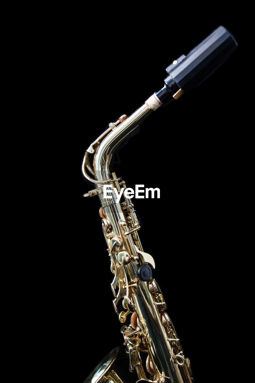 Saxophone against black background