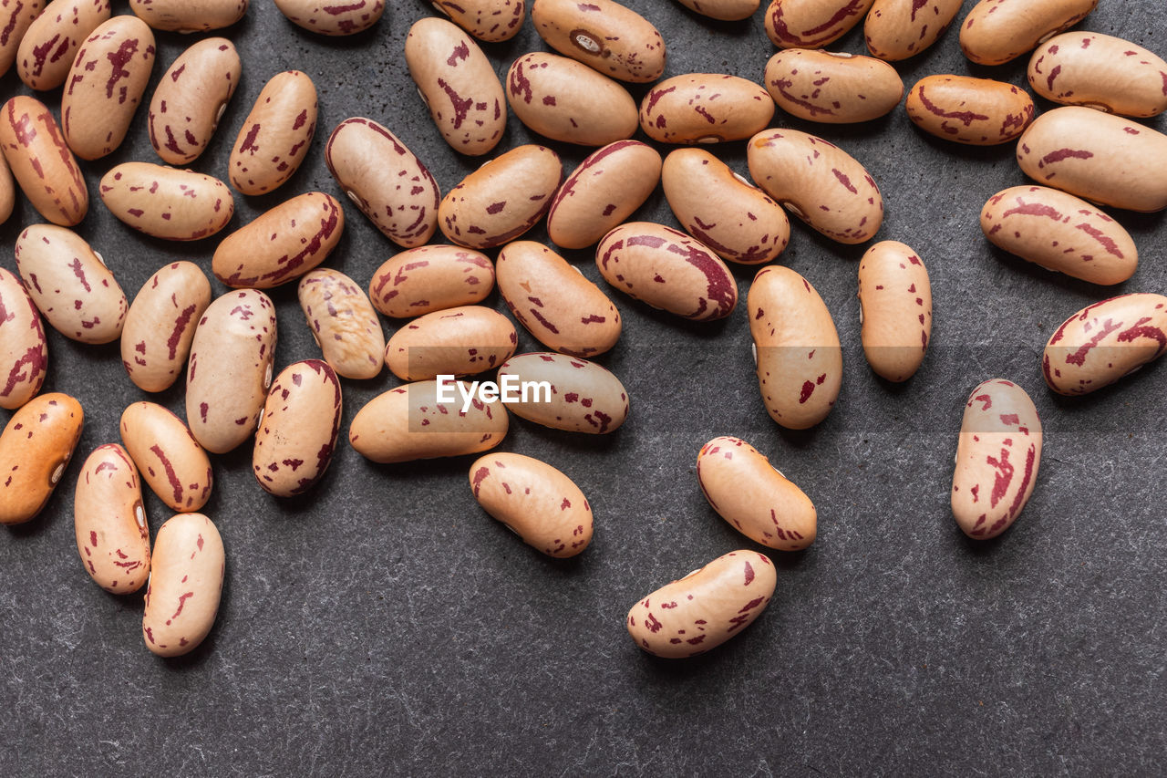 Close up of coffee beans with coffee powder as background