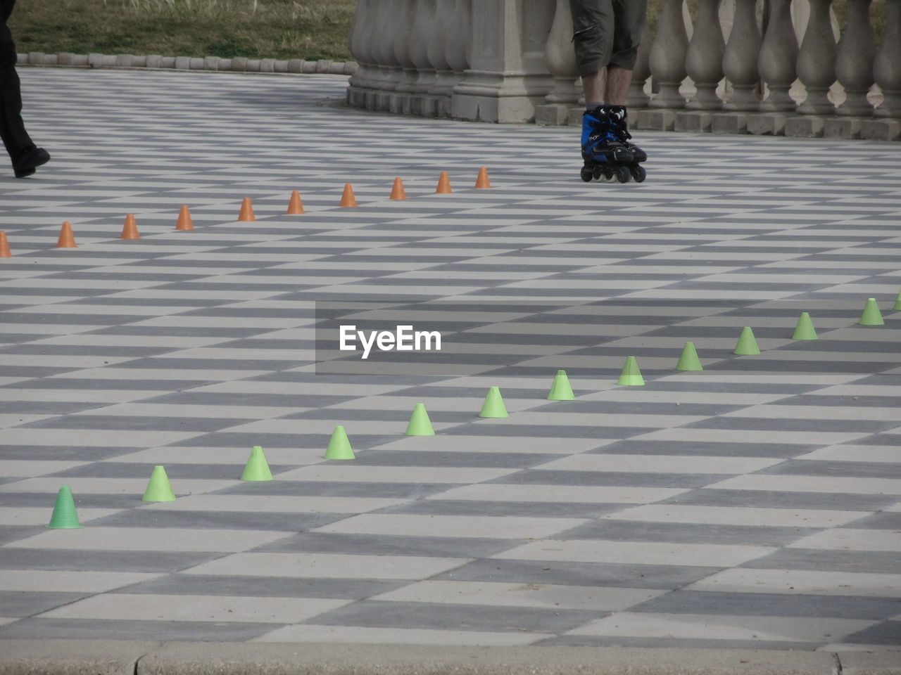 FULL LENGTH OF A MAN CYCLING IN ROW OF CHESS