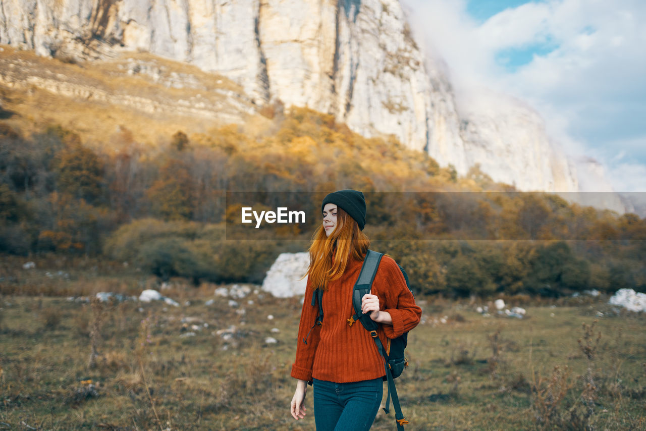 WOMAN STANDING ON MOUNTAIN