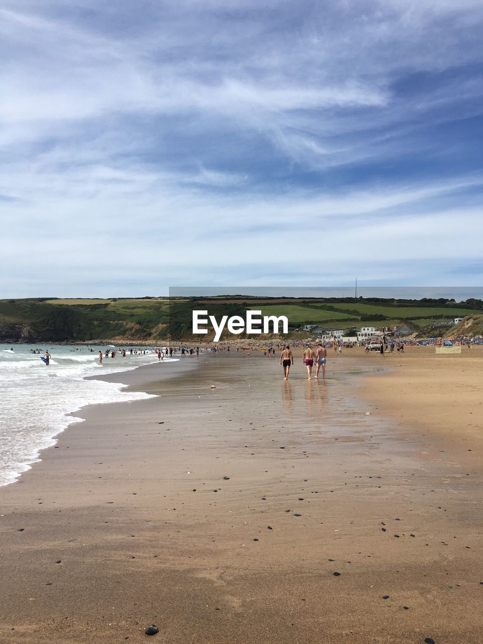 Scenic view of beach by mountain against sky