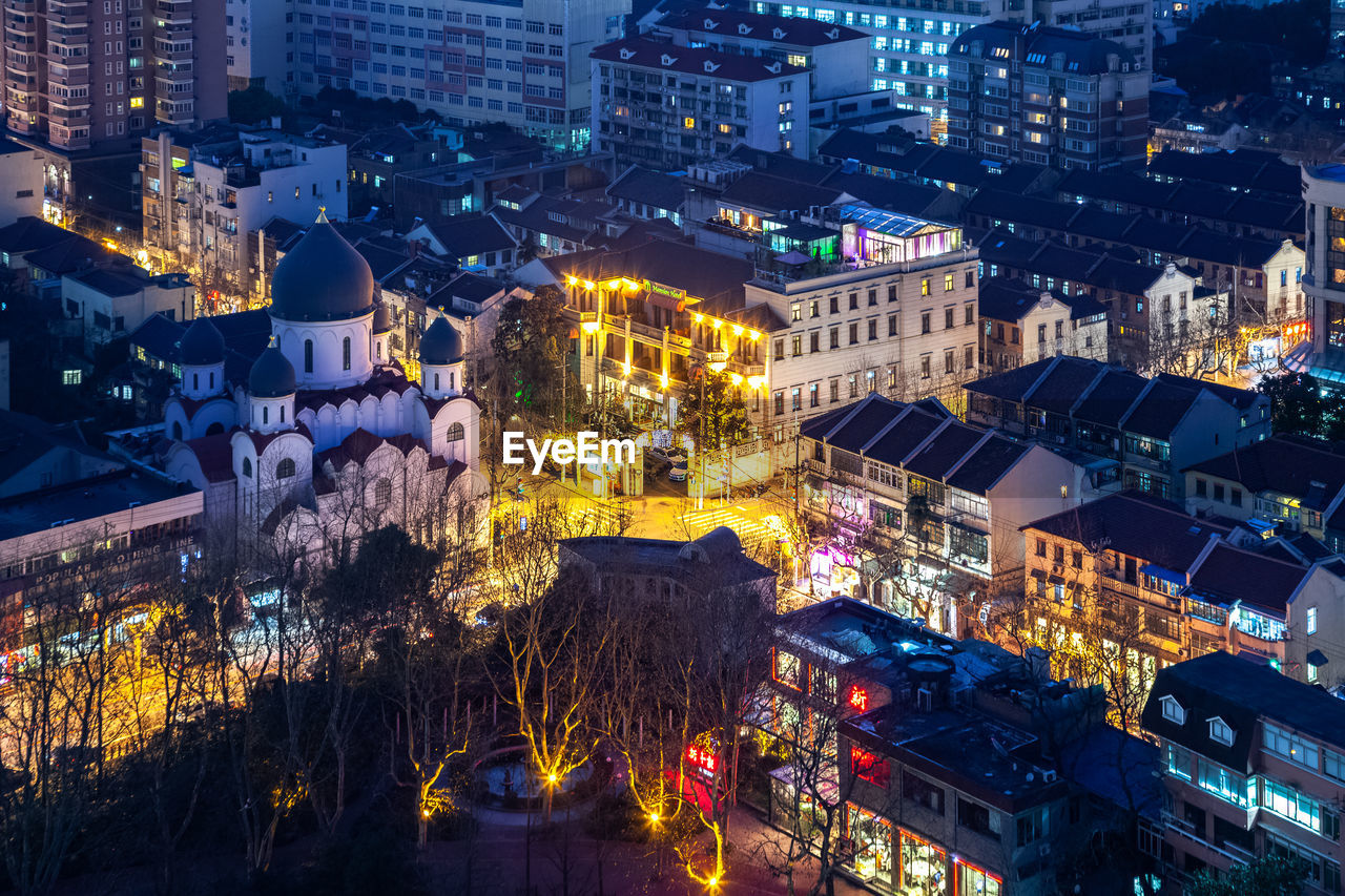 High angle view of city lit up at night