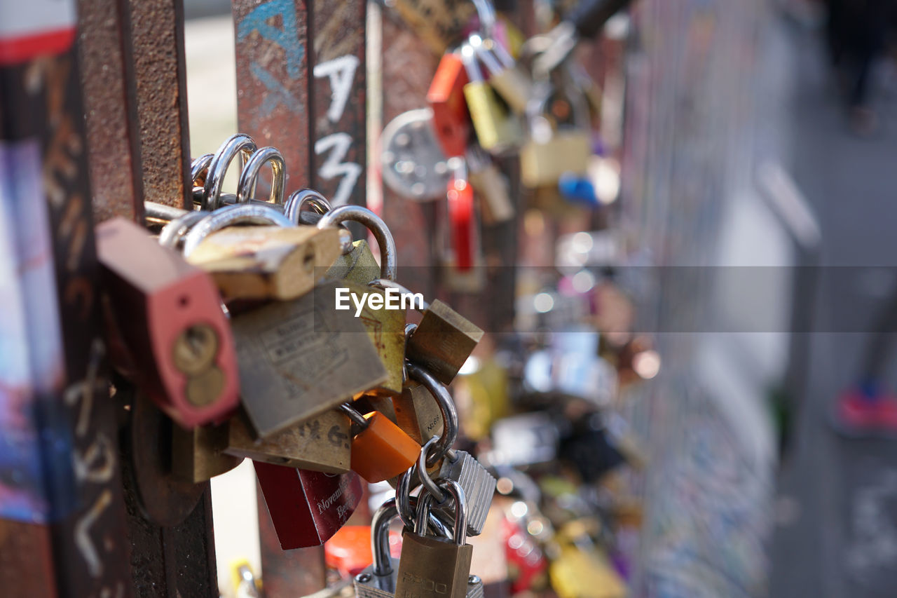 Close-up on the love padlocks mounted by a bridge. selective focus