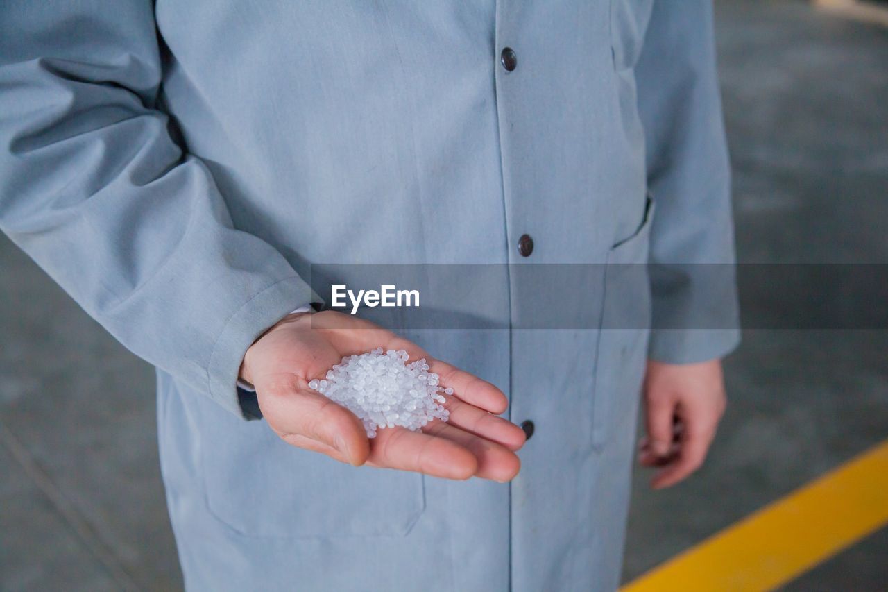 Close-up of hand holding white polystyrene balls