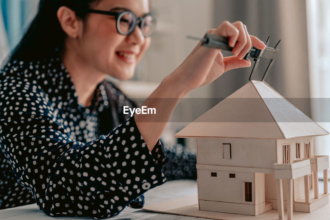 Architect making model house at home