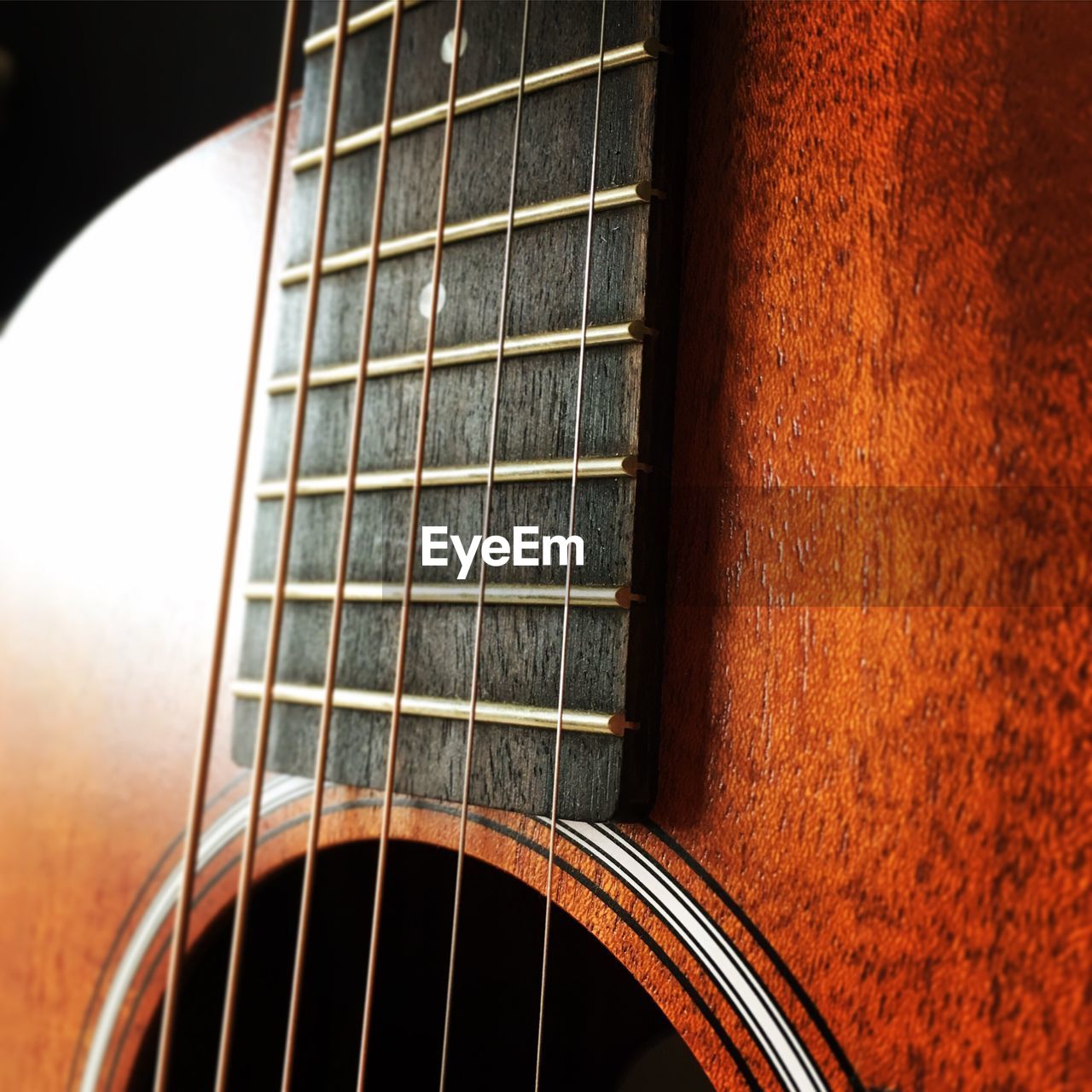 CLOSE-UP OF GUITAR IN THE DARK