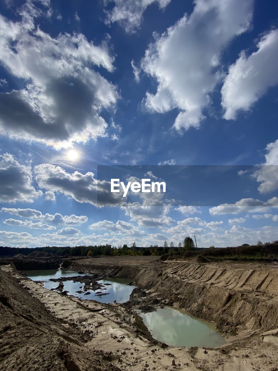 sky, cloud, nature, blue, reflection, sunlight, day, no people, outdoors, scenics - nature, low angle view, beauty in nature, environment, water, rock, tranquility