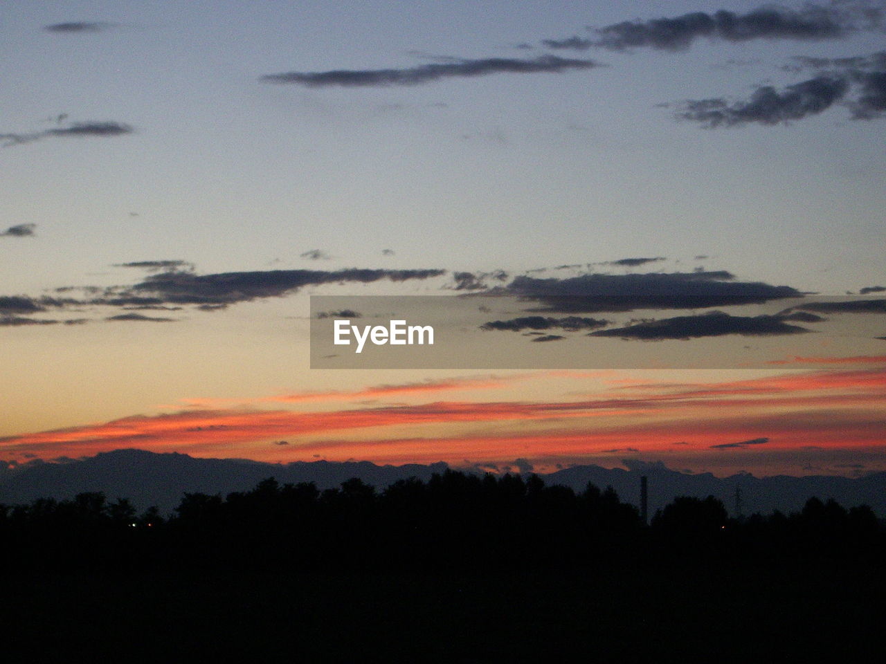 SCENIC VIEW OF DRAMATIC SKY OVER SILHOUETTE LANDSCAPE