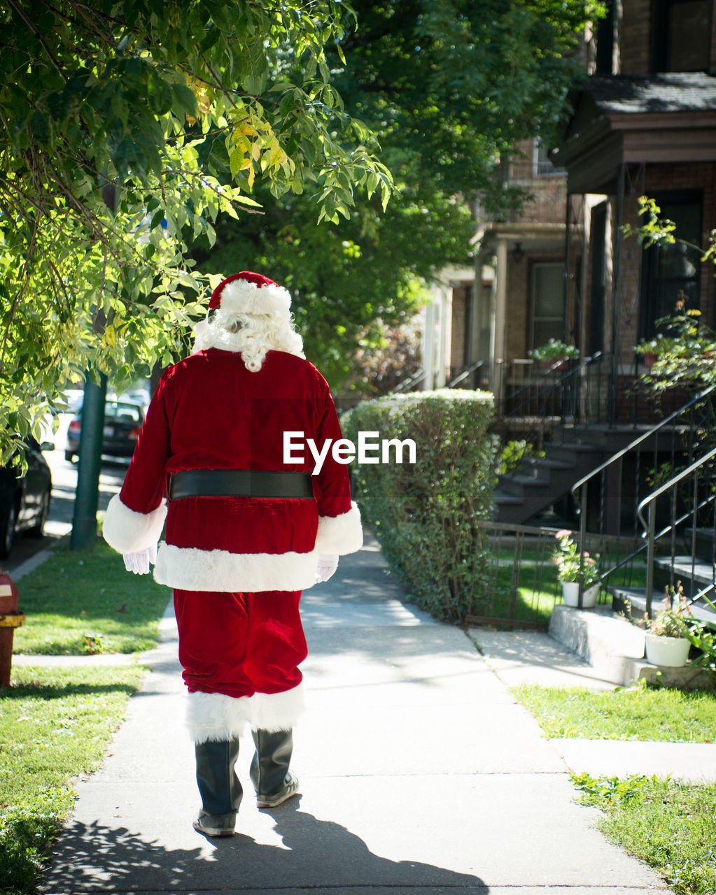 Rear view of santa walking in the city