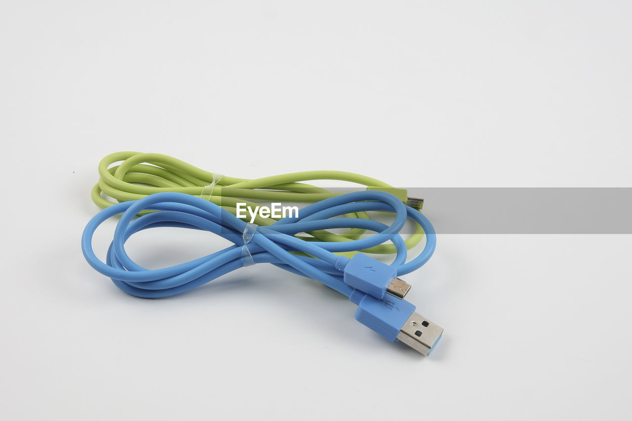 Close-up of usb cables over white background