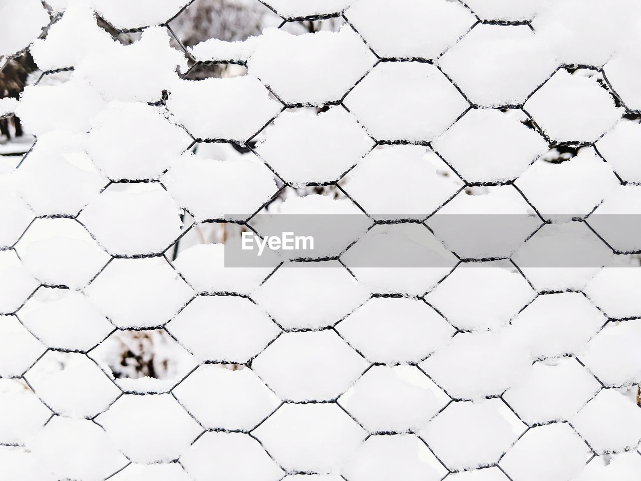 Full frame shot of snow on wire fence