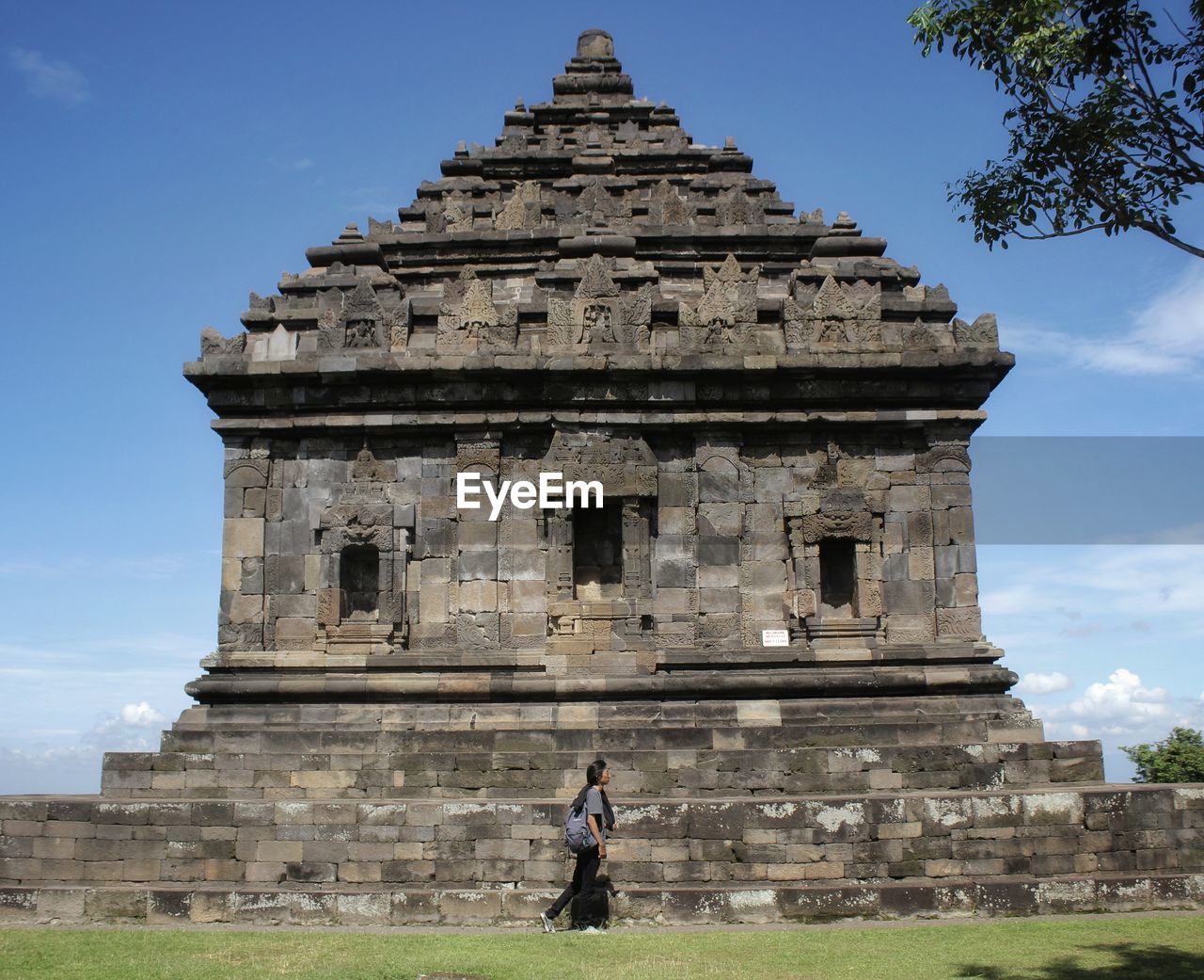 Woman walking outside historic temple