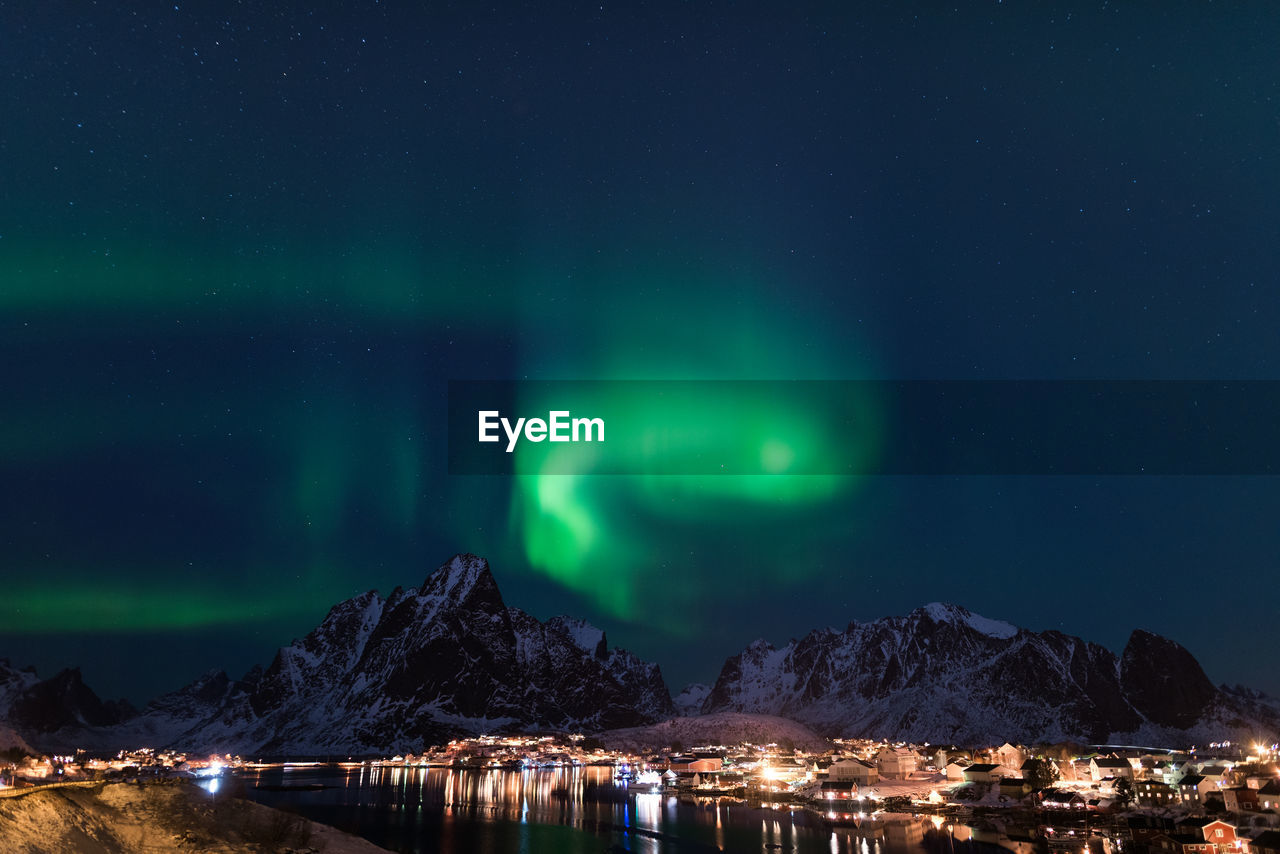 SCENIC VIEW OF ILLUMINATED MOUNTAIN AGAINST SKY AT NIGHT DURING WINTER