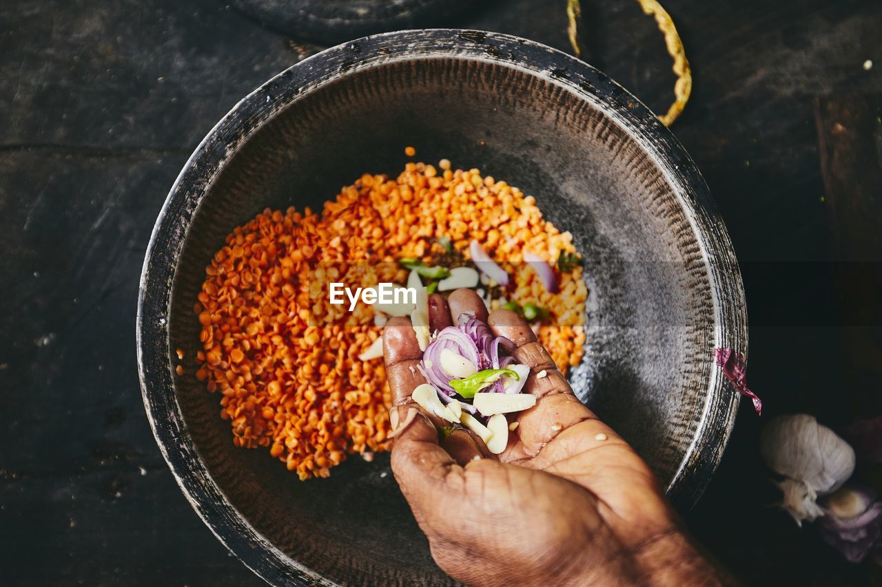 Cropped hand preparing food on table