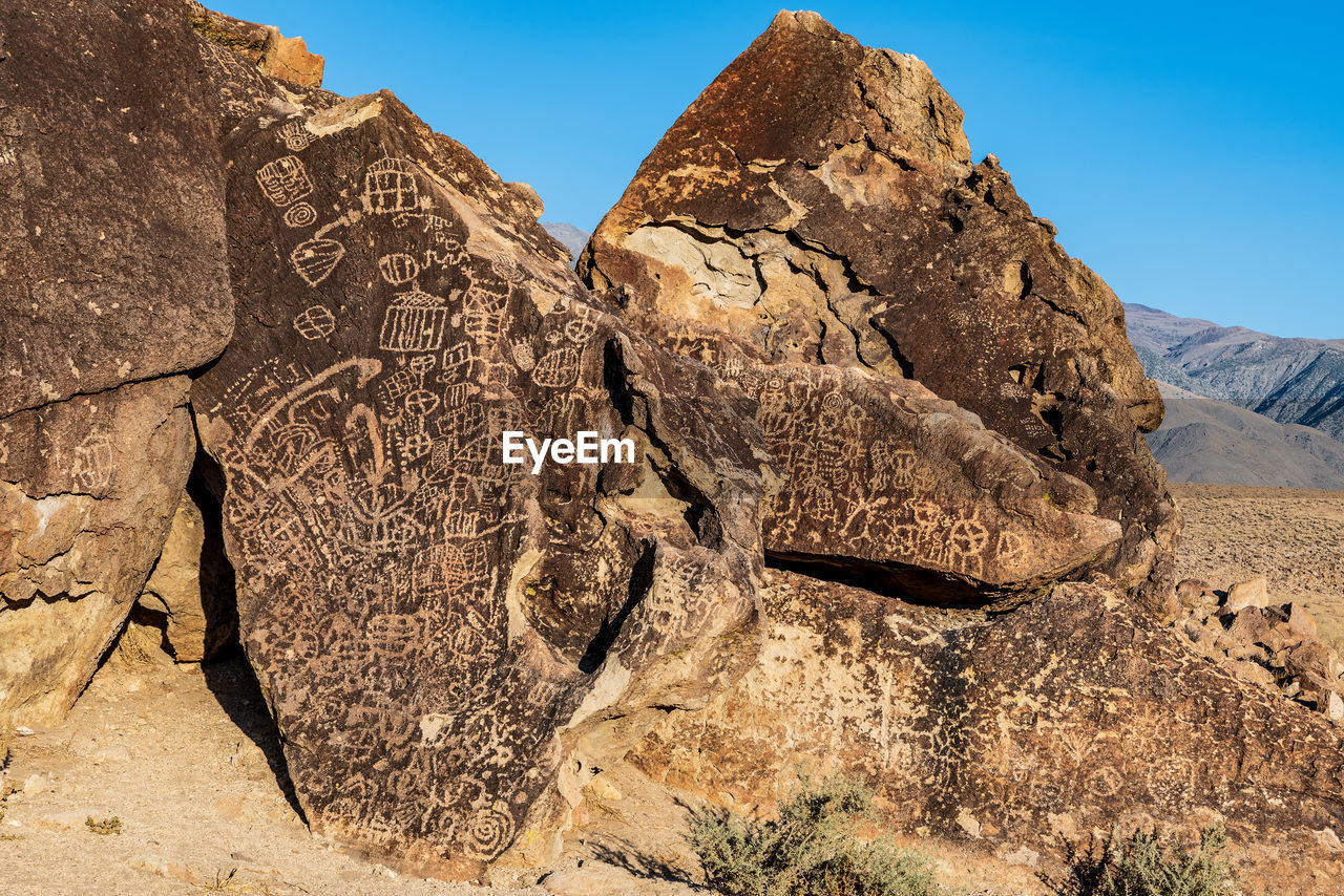 Ancient petroglyph symbols inscribed in  boulders by indigenous peoples of owens valley california