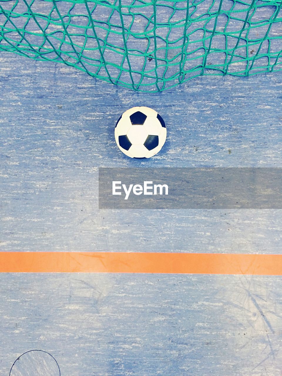 High angle view of soccer ball by net