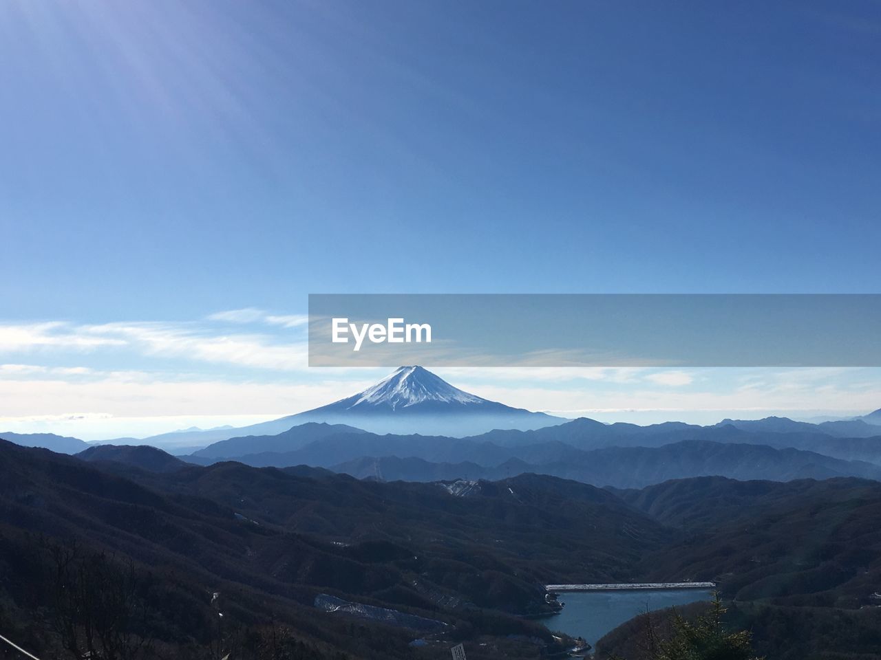 Scenic view of mountains against blue sky