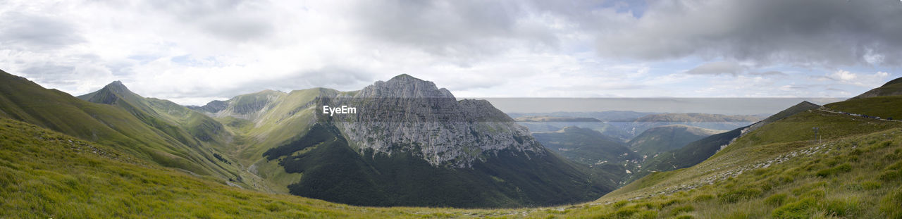 Panoramic view of landscape against cloudy sky