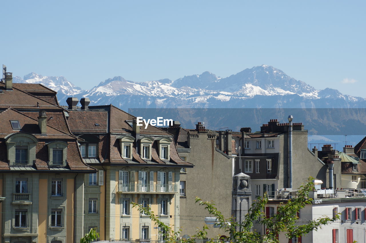 Houses in town against clear sky