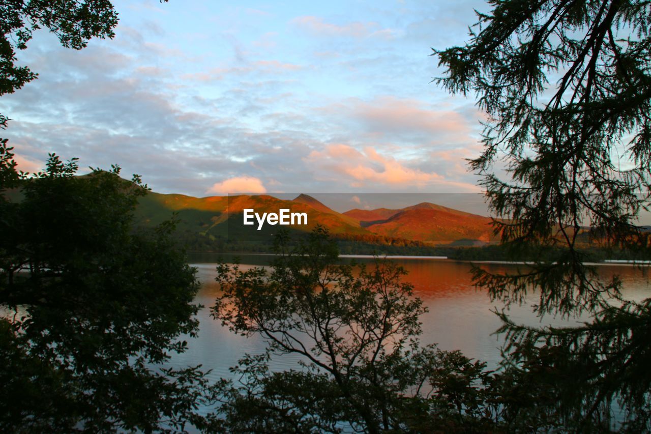 Scenic view of lake against cloudy sky