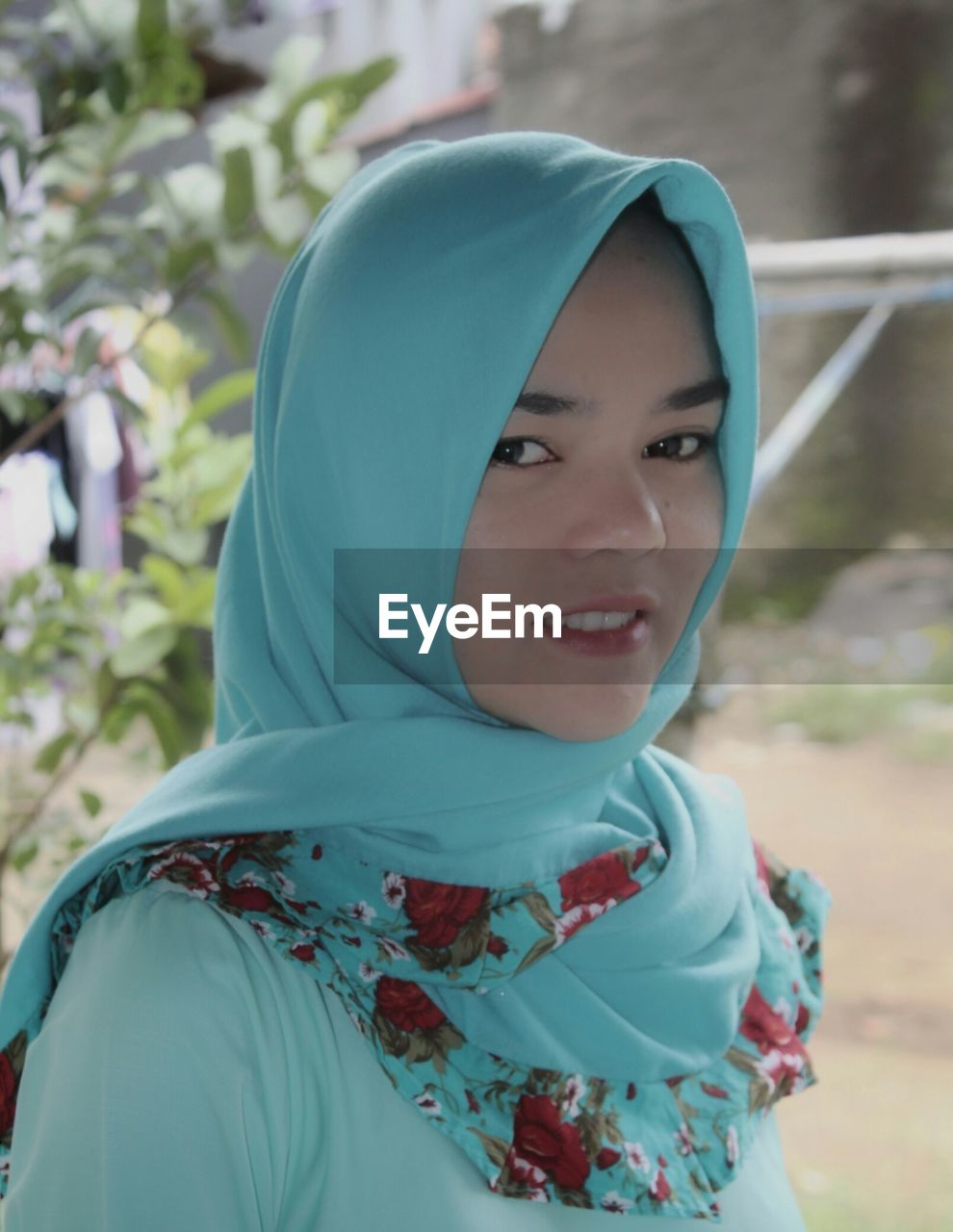 Close-up portrait of young woman in hijab outdoors