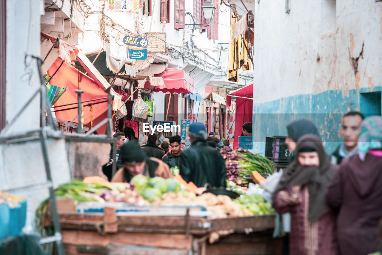 PEOPLE IN MARKET STALL