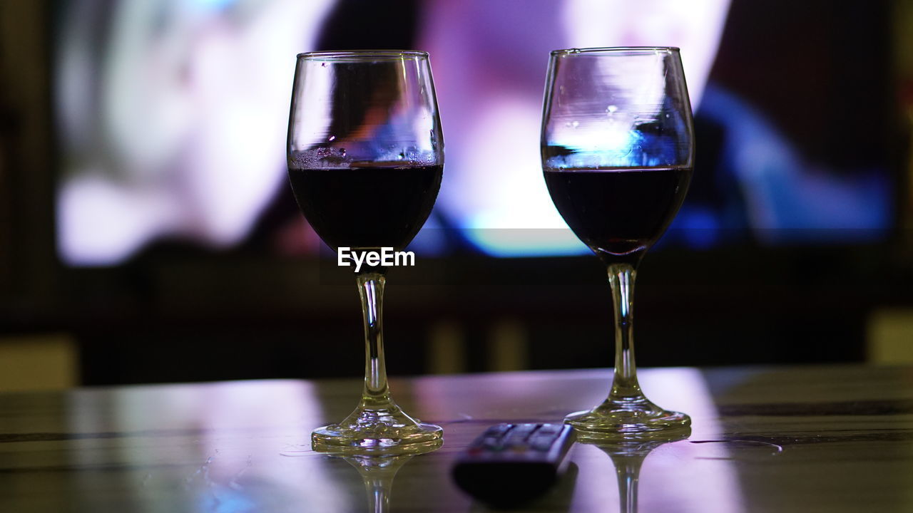 CLOSE-UP OF WINEGLASS ON TABLE