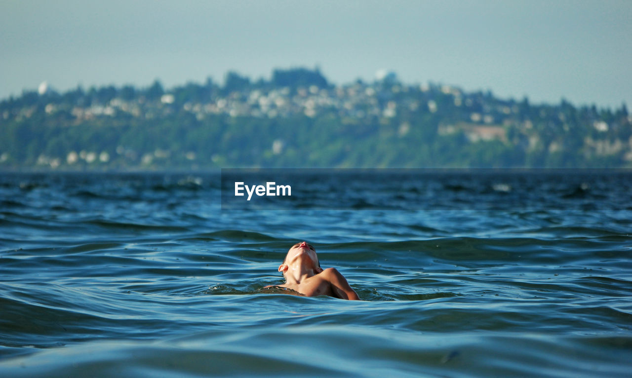 Boy swimming in sea