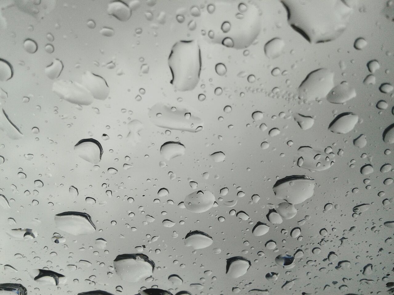 FULL FRAME SHOT OF RAINDROPS ON WATER DROPS