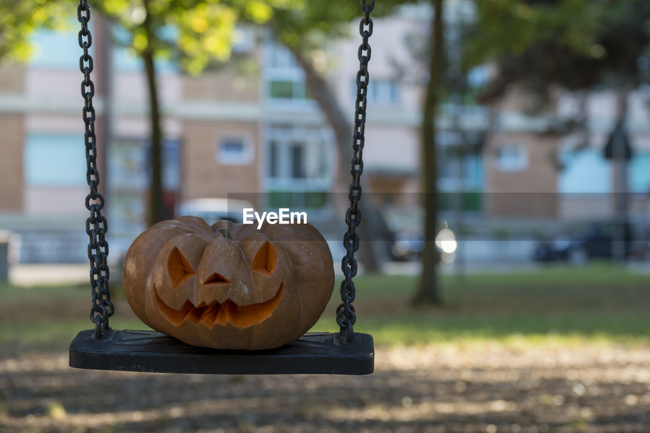 Close-up of swing hanging on playground